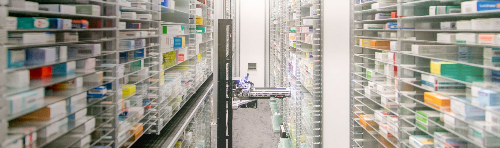 Pharmacy storage system with organized shelves of medication, highlighting service quality and efficiency.
